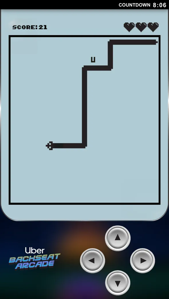 Retro-style Snake game screen showing a snake chasing the letter U with a score of 21 and three hearts, and directional arrow controls below.