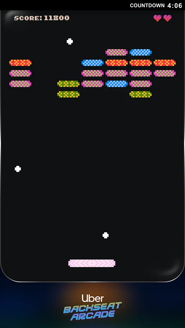 Pixelated brick breaker game screen showing colored bricks, two hearts, score 11800, and countdown 4:06 in retro arcade style with Uber Backseat Arcade logo below.